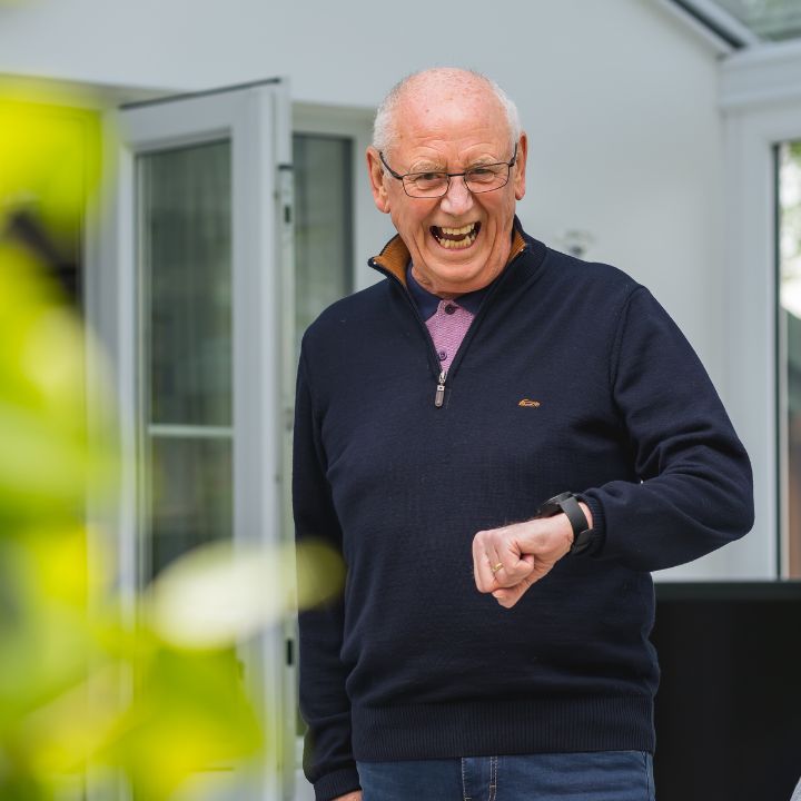 A man smiling with his watch.