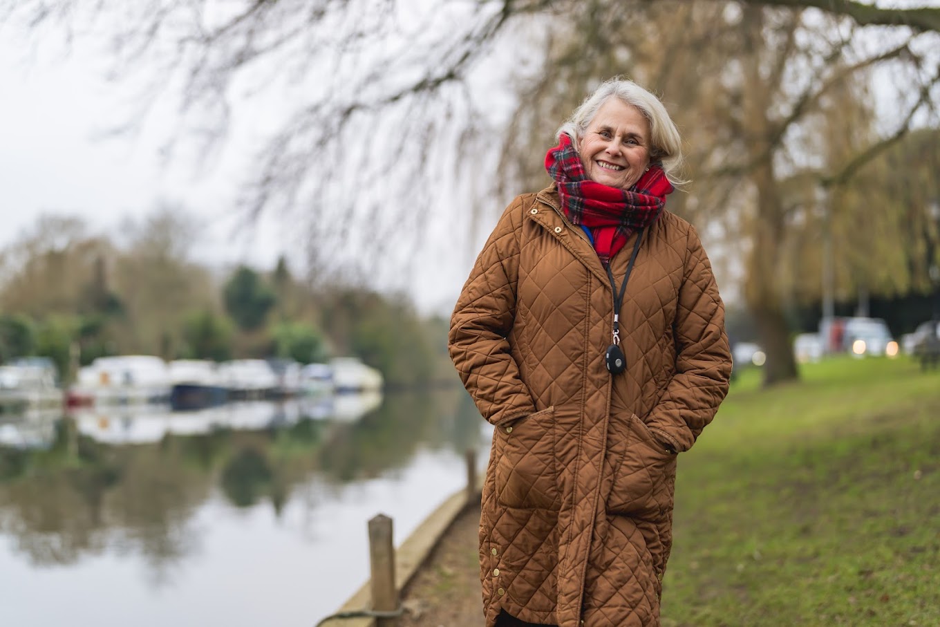 A happy lady outdoors with her pendant.